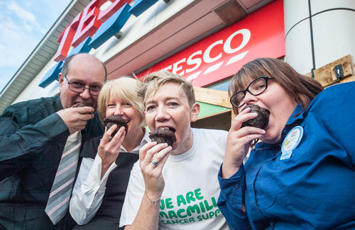 Biting into Tesco muffins are Graham Hobbins (Brakes Trust), Cathy Wahlberg (Operations and Finance Member from Alsters Kelley LLP), Catherine Thomson (representing Macmillan) and Sarah Wrist (Warwick Tesco).